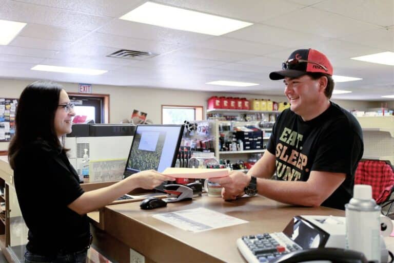 Blogs 2 A DeWitt County Producers employee helping a customer at the Cuero store counter.