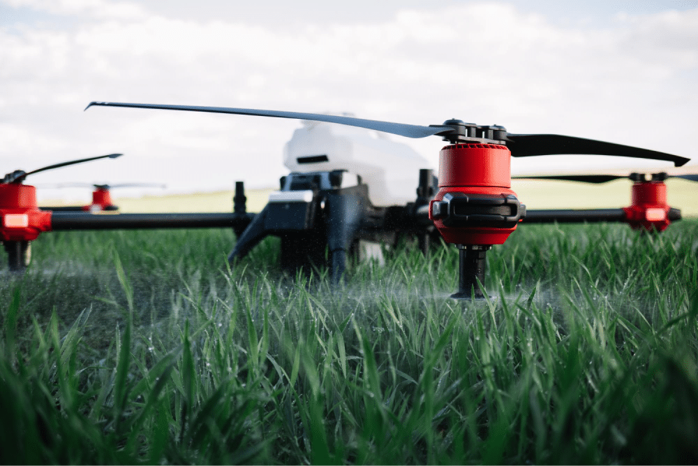 Drone spraying crops in field.